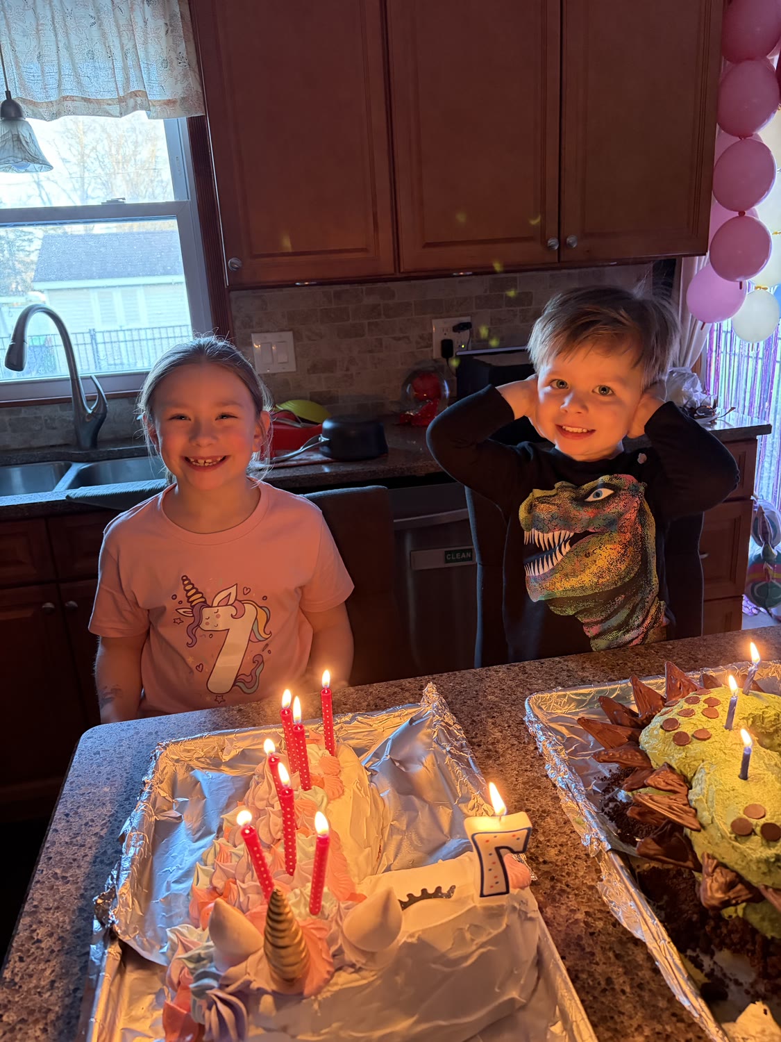 Jake's two kids at a birthday celebration with homemade cakes